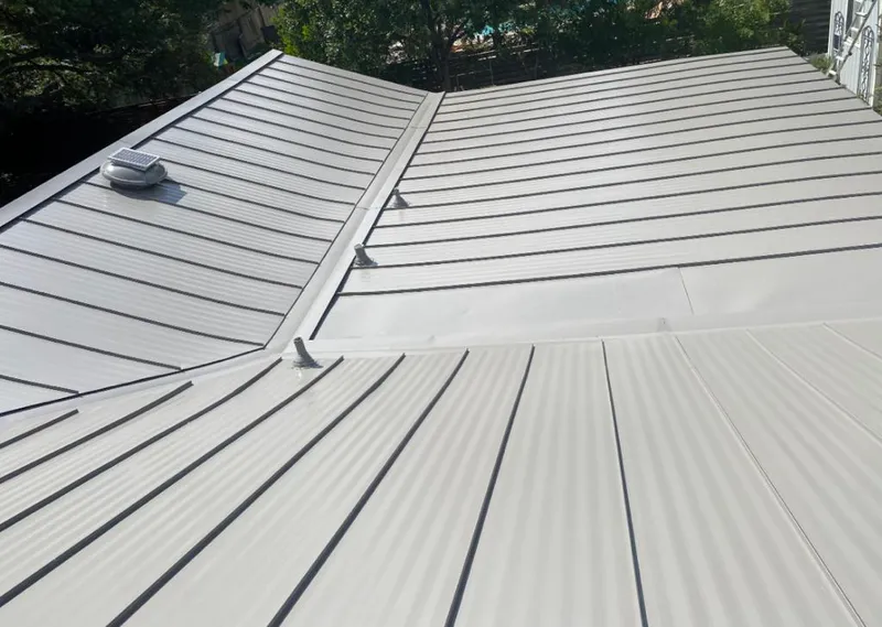 Solar attic fan installed on a metal roof for Roof Ventilation in Denton